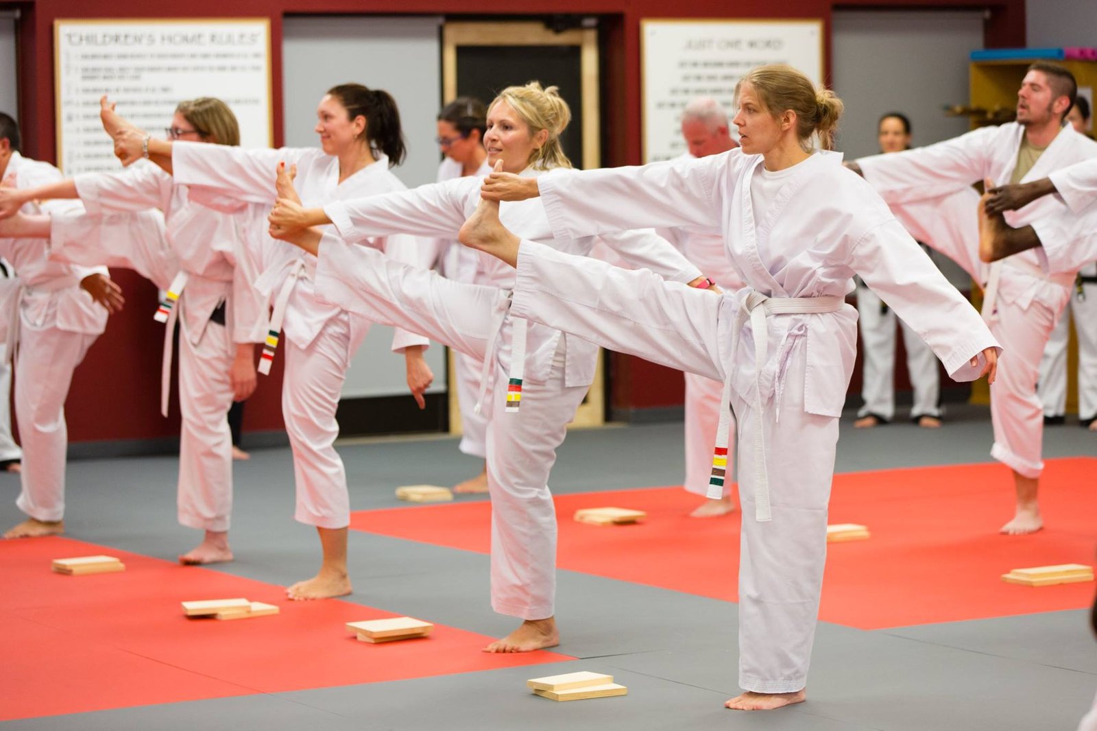 Adult students stretching together at JK Lee