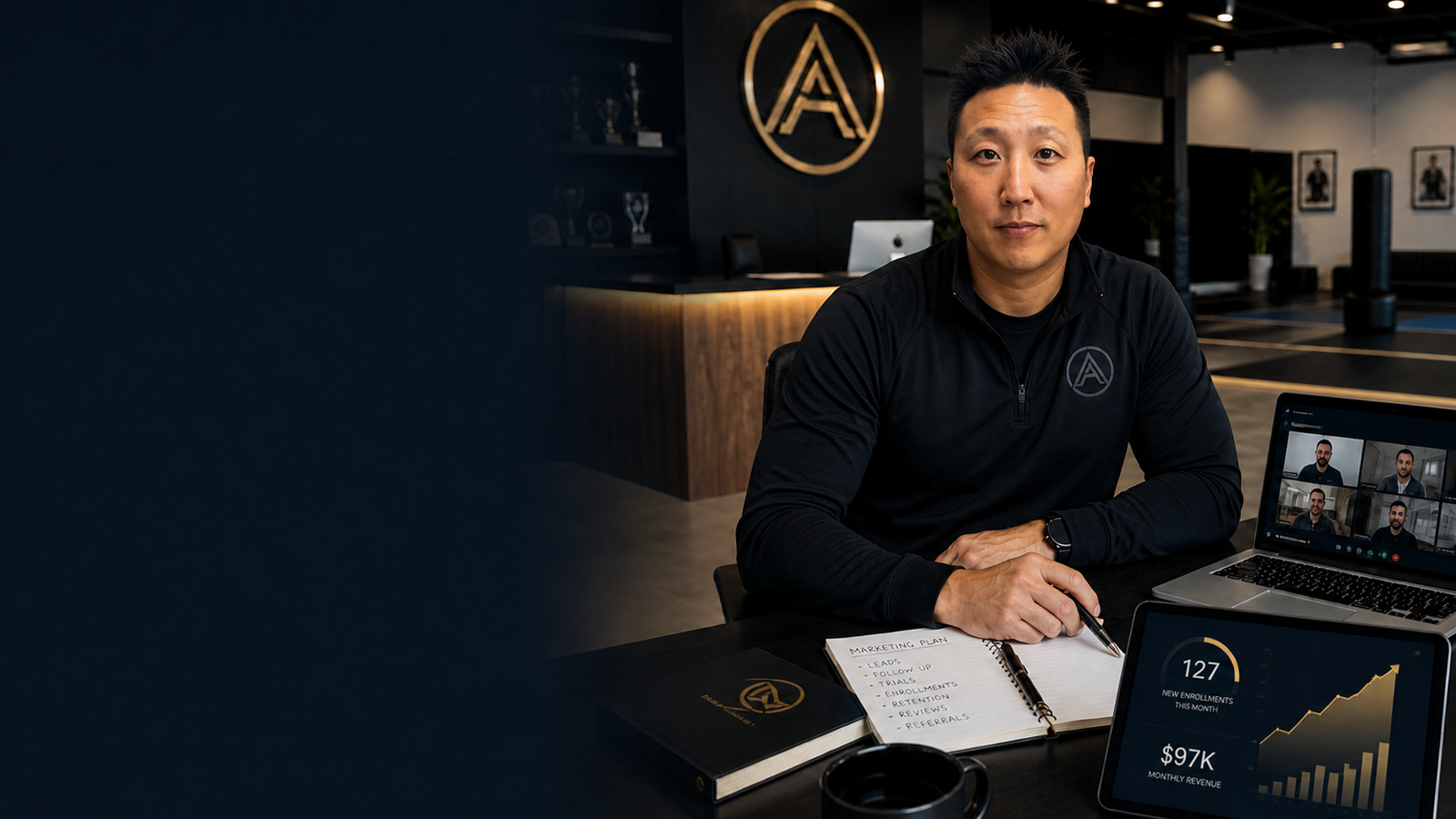 Martial arts school owner reviewing marketing plan and revenue dashboard with ASA Live coaching call
